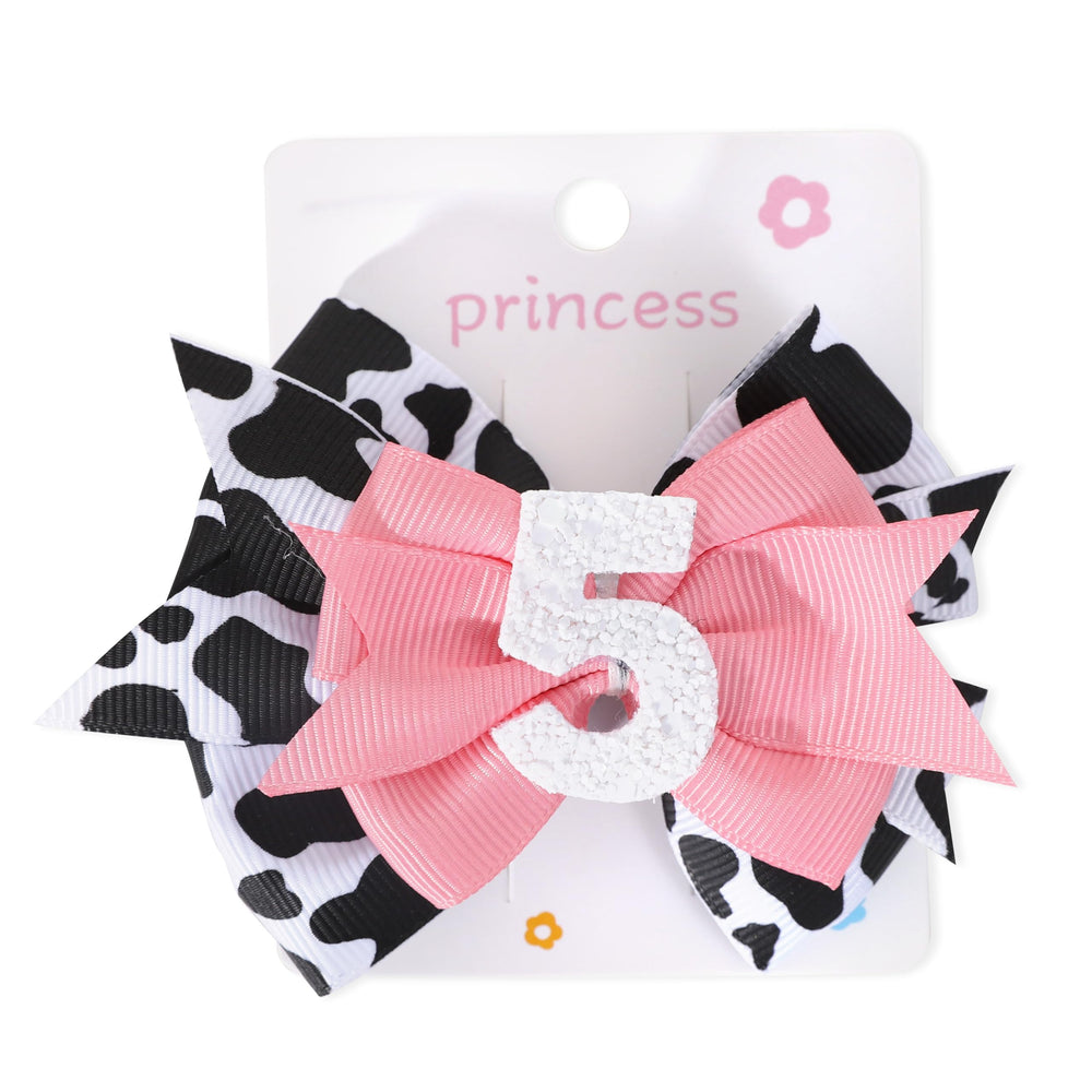 Jissoo cow print bow headband packaging shot, durable materials for repeated use.