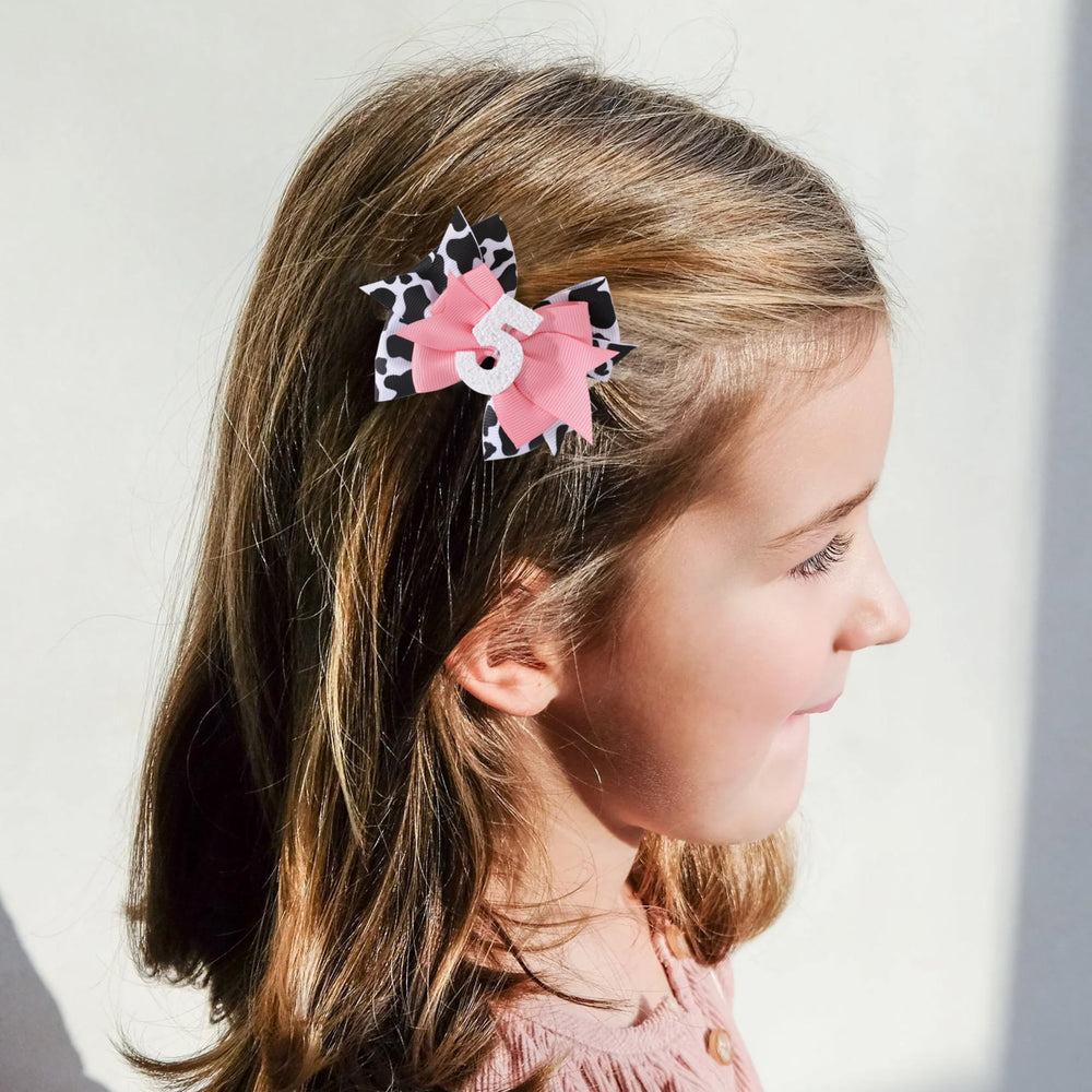 Jissoo cow print bow headband side view, easy-to-adjust elastic for comfortable wear.