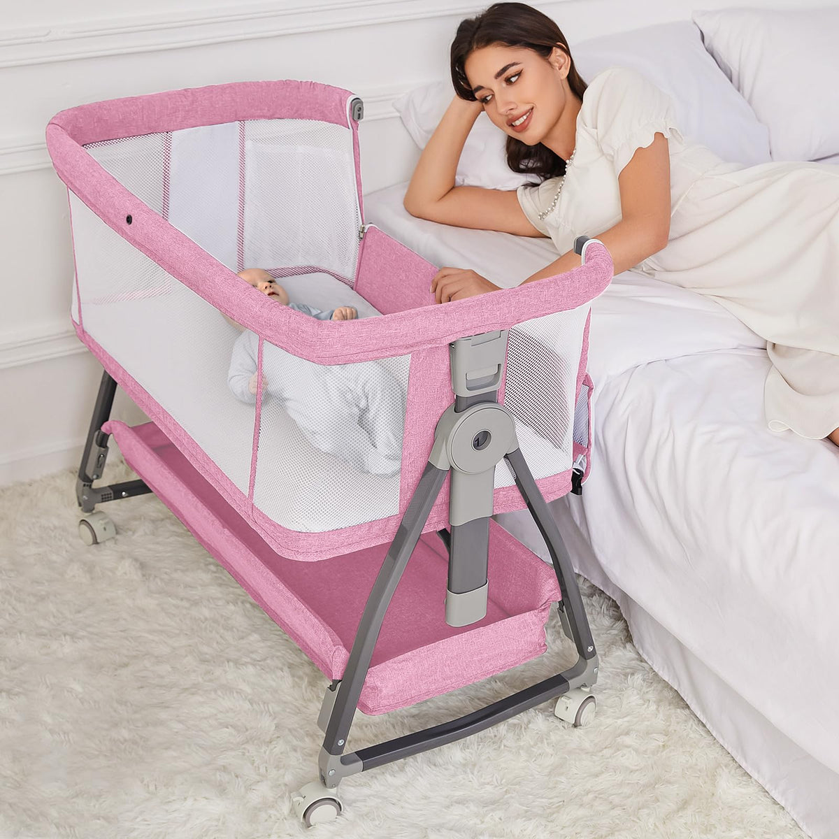 Jixrolyn pink bassinet standalone crib offers a compact newborn sleep space.