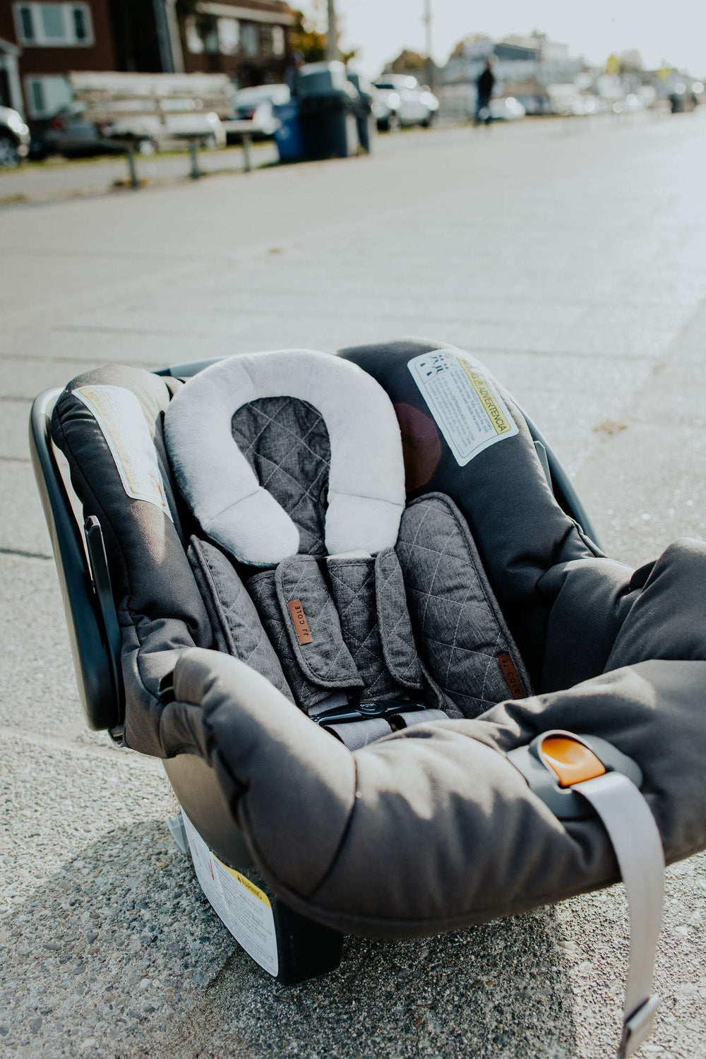 JJ Cole car-seat strap cover supports both infant and booster scenarios.