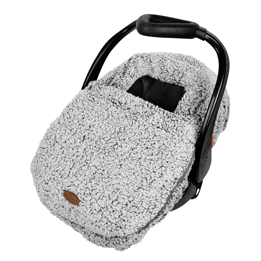 JJ Cole winter car seat cover with sherpa lining over baby in a stroller