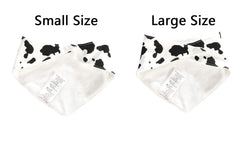 JN&LULU cow-pattern bibs worn by baby during play.
