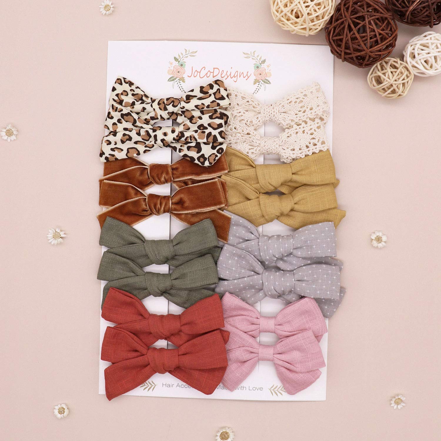 JoCoDesigns sage linen bow clip complements soft outfits with gentle grip