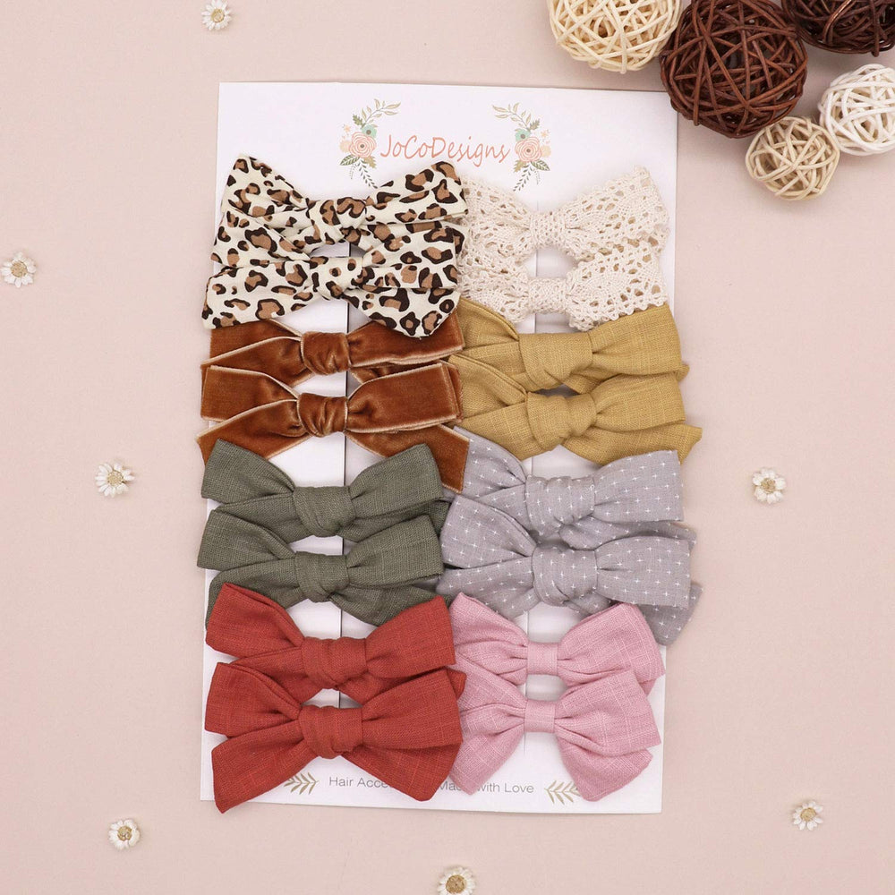 JoCoDesigns sage linen bow clip complements soft outfits with gentle grip