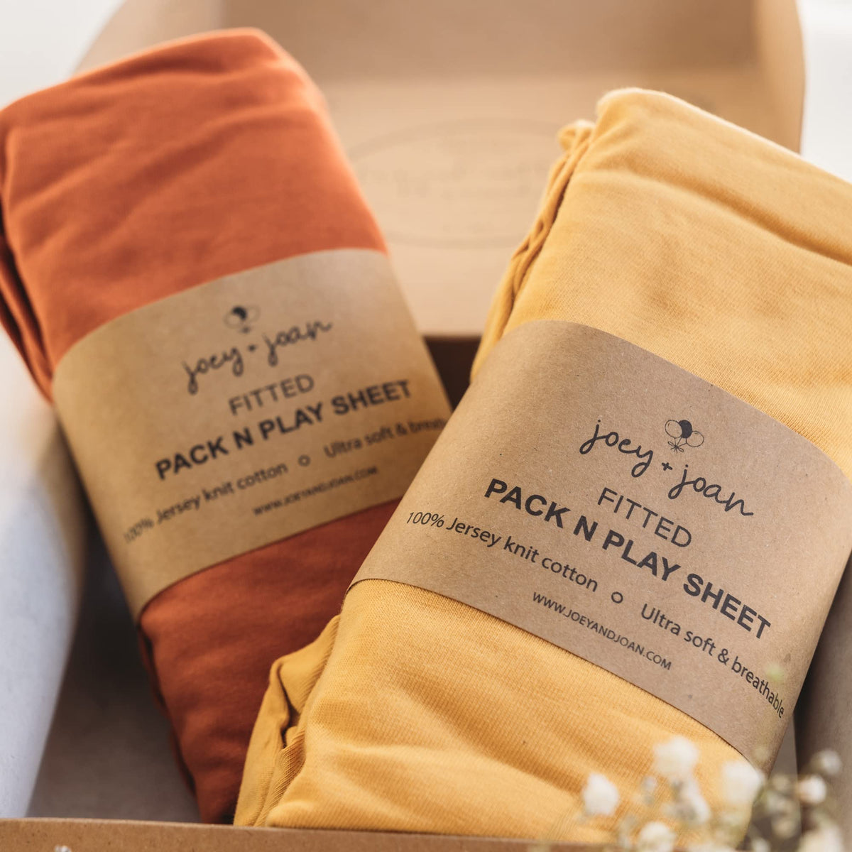 Joey + Joan fitted sheet in mustard yellow and burnt orange, silky jersey cotton for baby comfort.