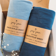 Joey + Joan travel crib fitted sheet in dusty blue, ultra-soft 100% jersey cotton for gentle sleep.