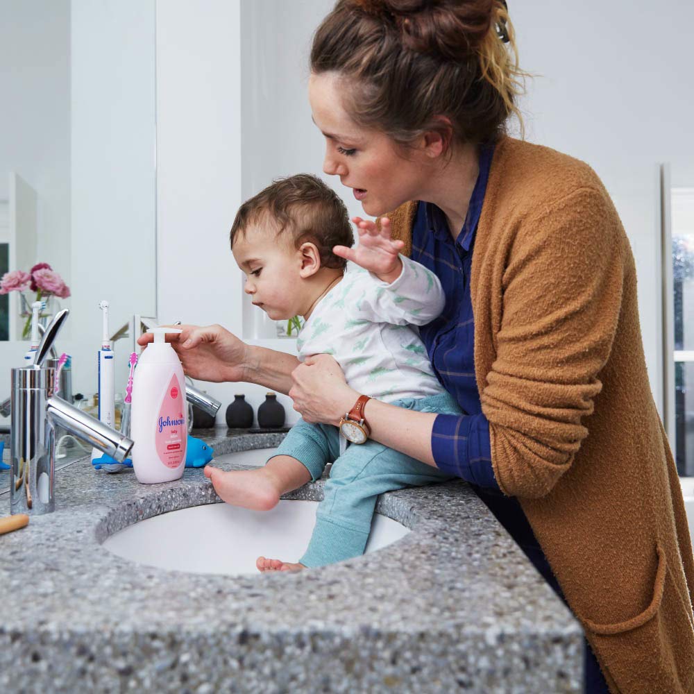 Johnson's Baby Lotion cap-off pump demonstrates easy one-hand application.