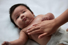 Johnson's Baby Oil on baby skin shows silky barrier against dryness.
