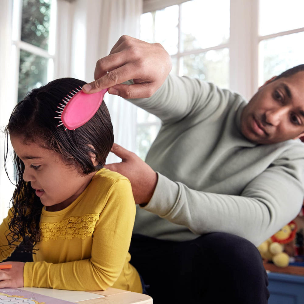 Johnson's No More Tangles Shampoo kid brushing hair shows easy detangling routine.