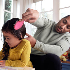 Johnson's No More Tangles Shampoo kid brushing hair shows easy detangling routine.