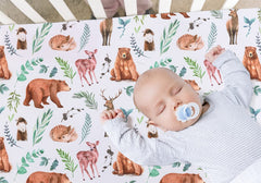 Jola's House woodland design crib sheets in forest colors for a warm nursery.