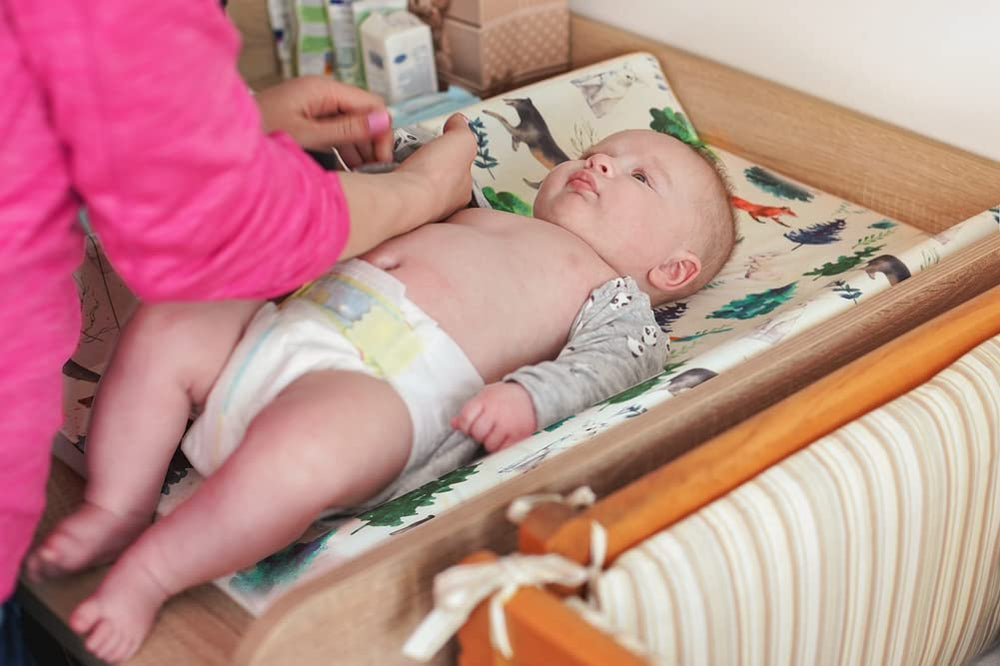 Jola's House woodland-changing pad cover brightens a nursery and stays durable in washes.