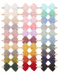 Jollybows 30pcs baby bows on linen headbands, gentle and breathable for delicate baby skin.