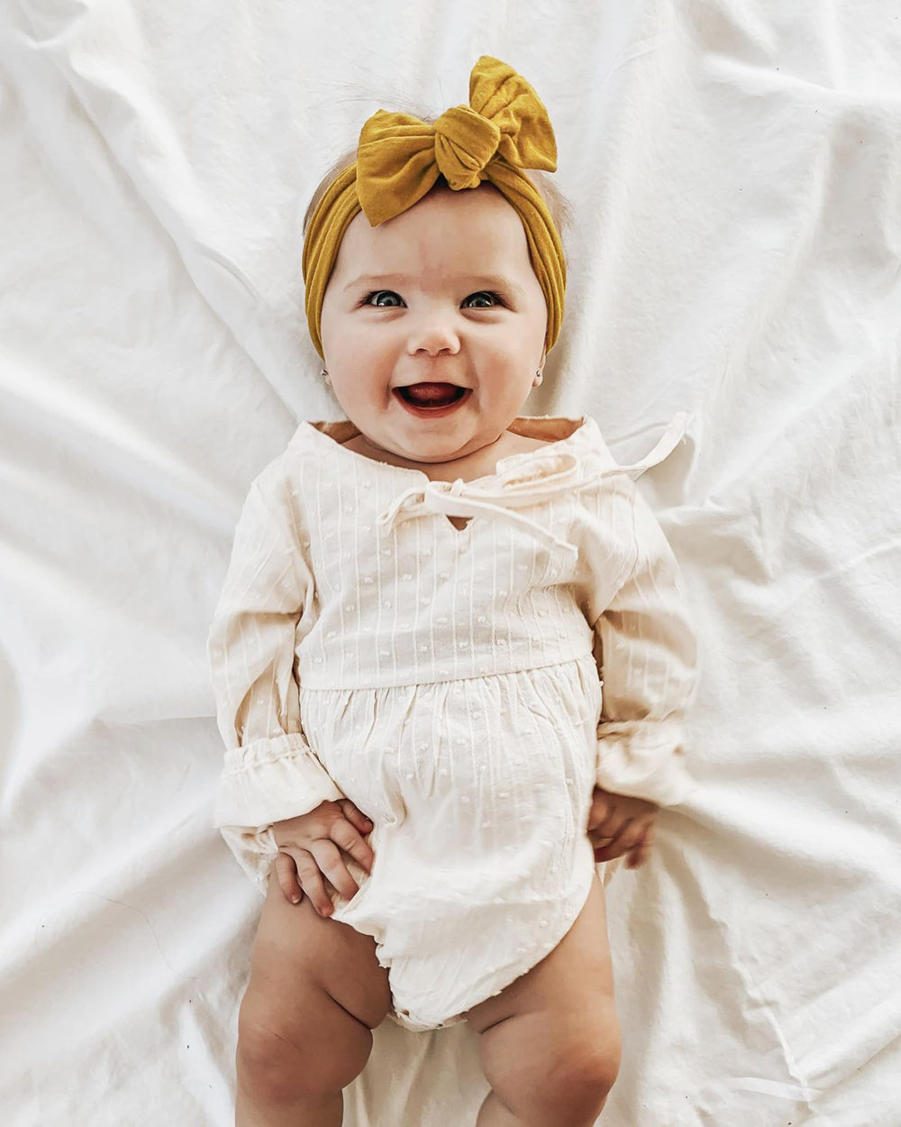 Jollybows headband with bow demonstrates a comfy, secure fit for tiny heads