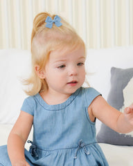 Jollybows mini bow 2in cream adds subtle shine to toddler hairstyles.