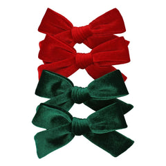 Jomila 4pcs velvet bow hair clips in green and red for festive looks.