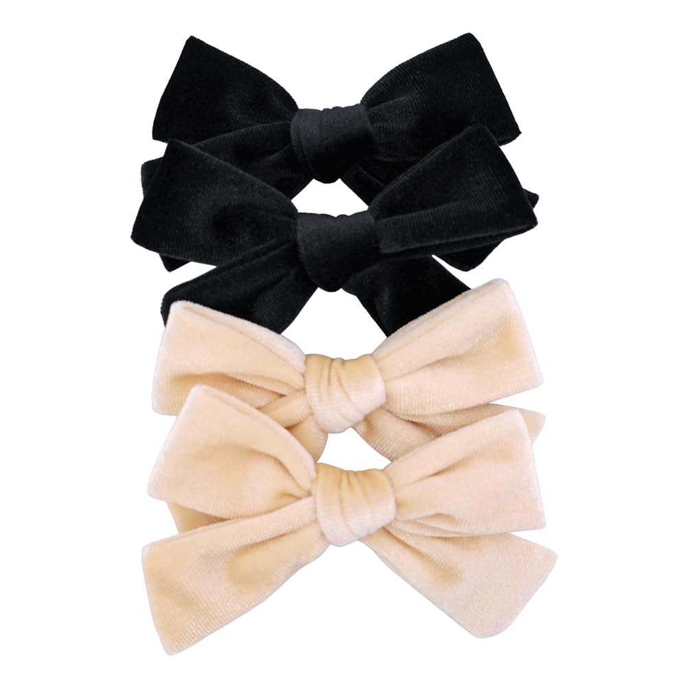 Jomila velvet bow hair clip closeup shows luxe texture in black and cream.
