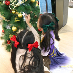Jomila velvet bow hair clip closeup texture highlights soft lustrous finish.