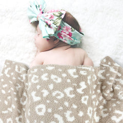 JOOJA beige cheetah knit blanket showing versatile textile design for nursery decor.