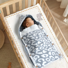 JOOJA swaddle with wooden-buttons-hooded design provides adjustable comfort.