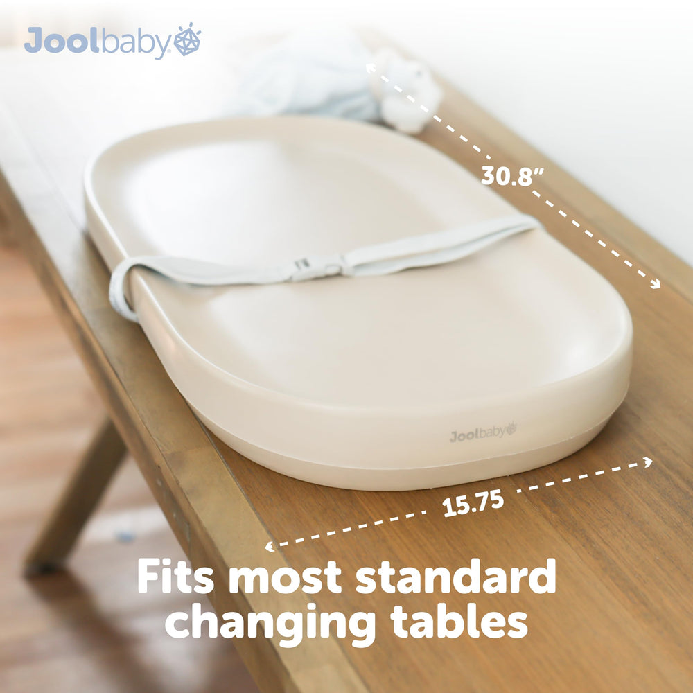 Jool Baby changing pad with safety strap keeping baby secure during changes