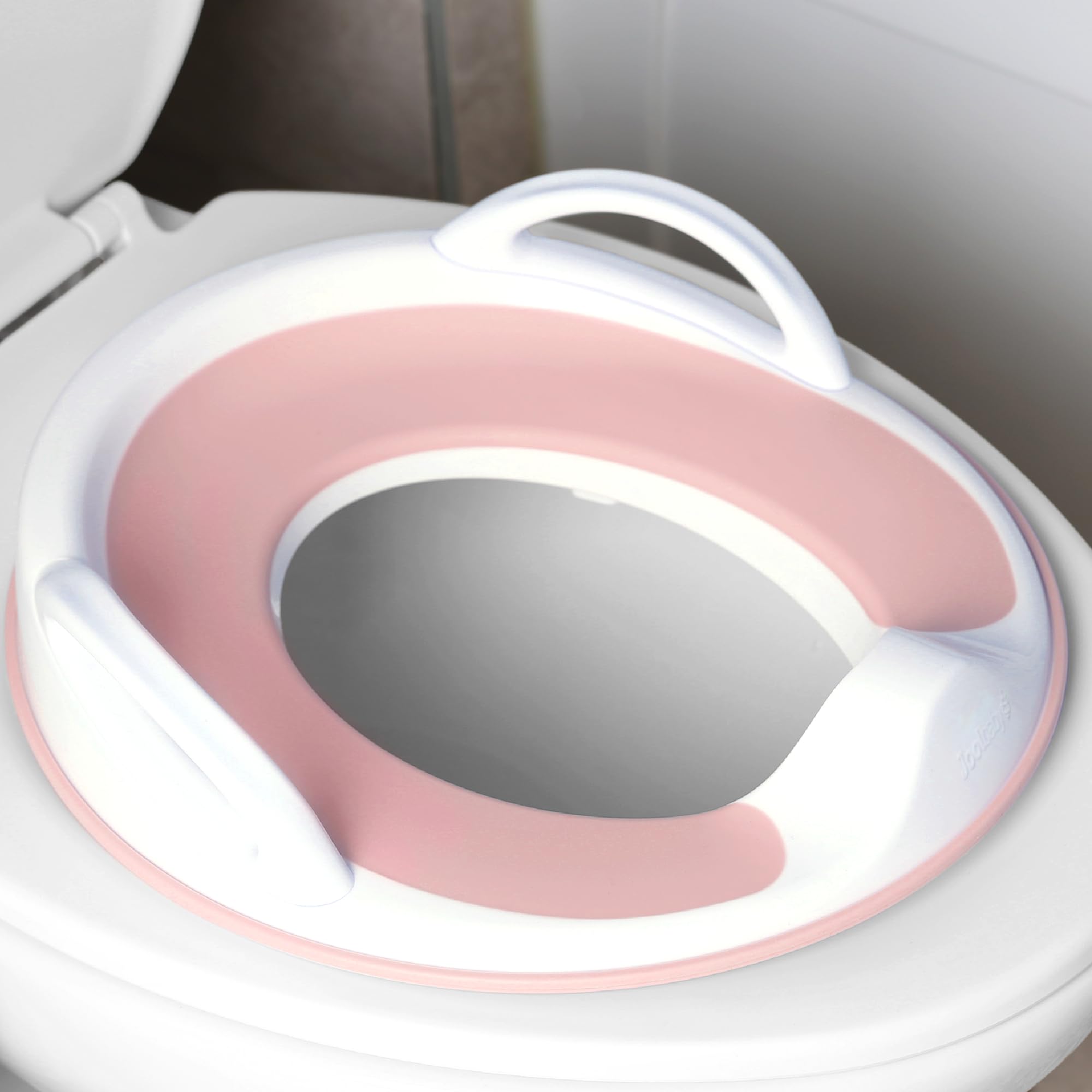 Jool Baby pink potty seat with handles providing secure grip for toddlers