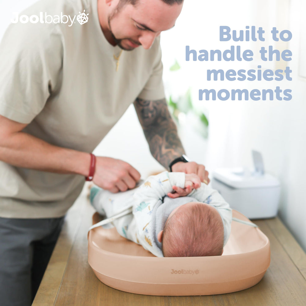 jool baby peach changing pad surface is wipe-clean for quick mess cleanup