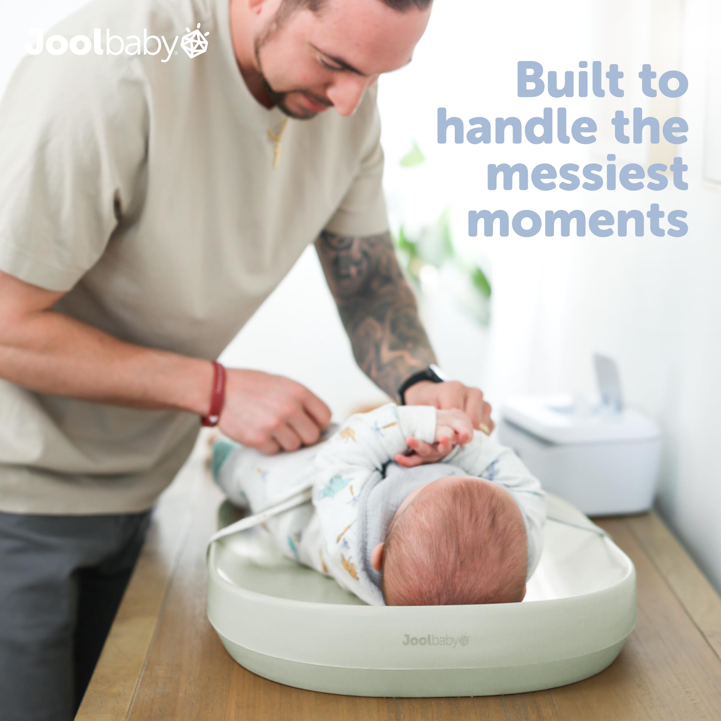Jool Baby Sage changing pad with raised edges supports safe, mess-free diaper changes.