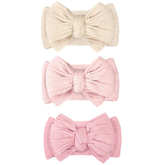 JOYOYO beige double-bow headband keeps hair away from the face during playtime.