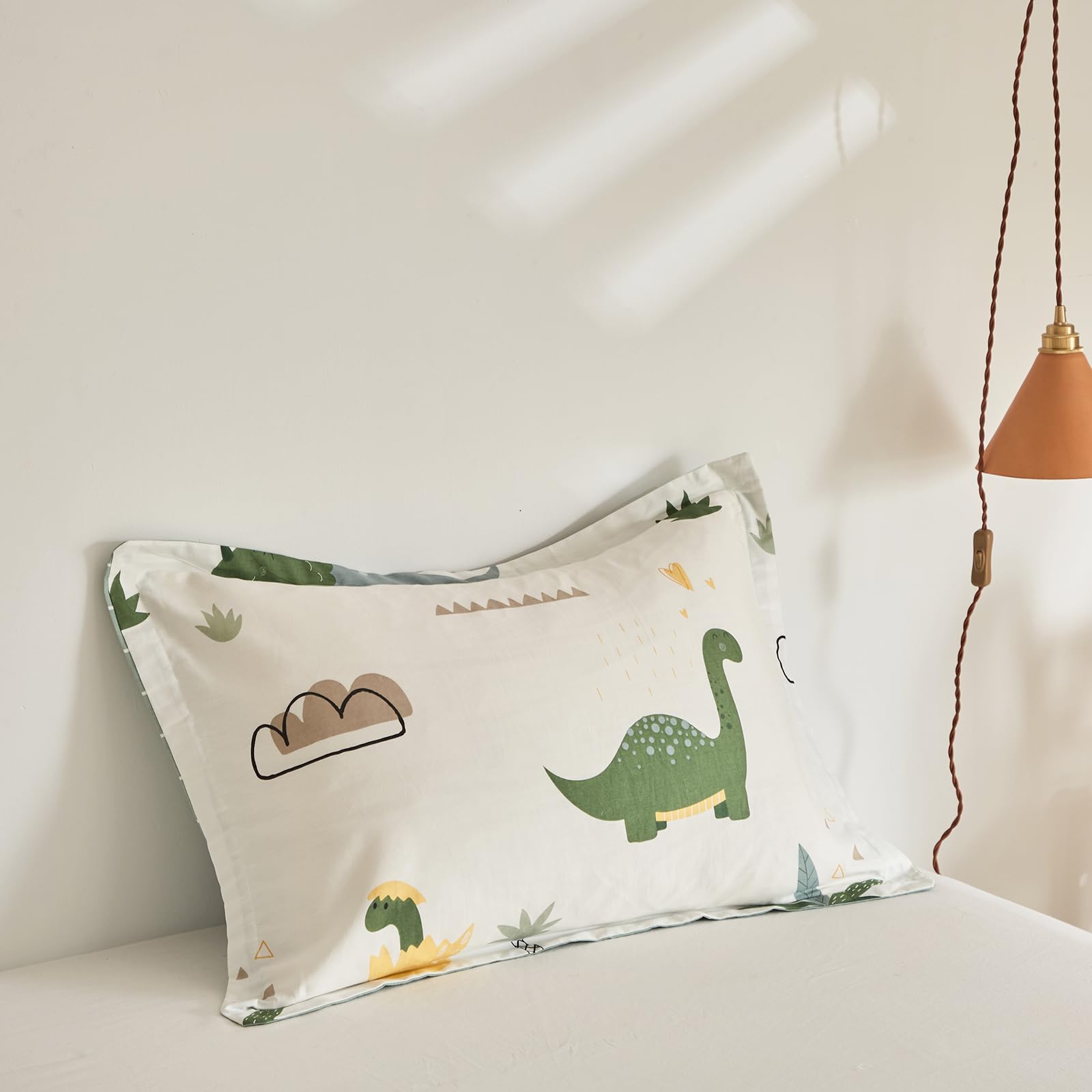 Joyreap dinosaur bedding design closeup highlights playful greens and kid-friendly details.