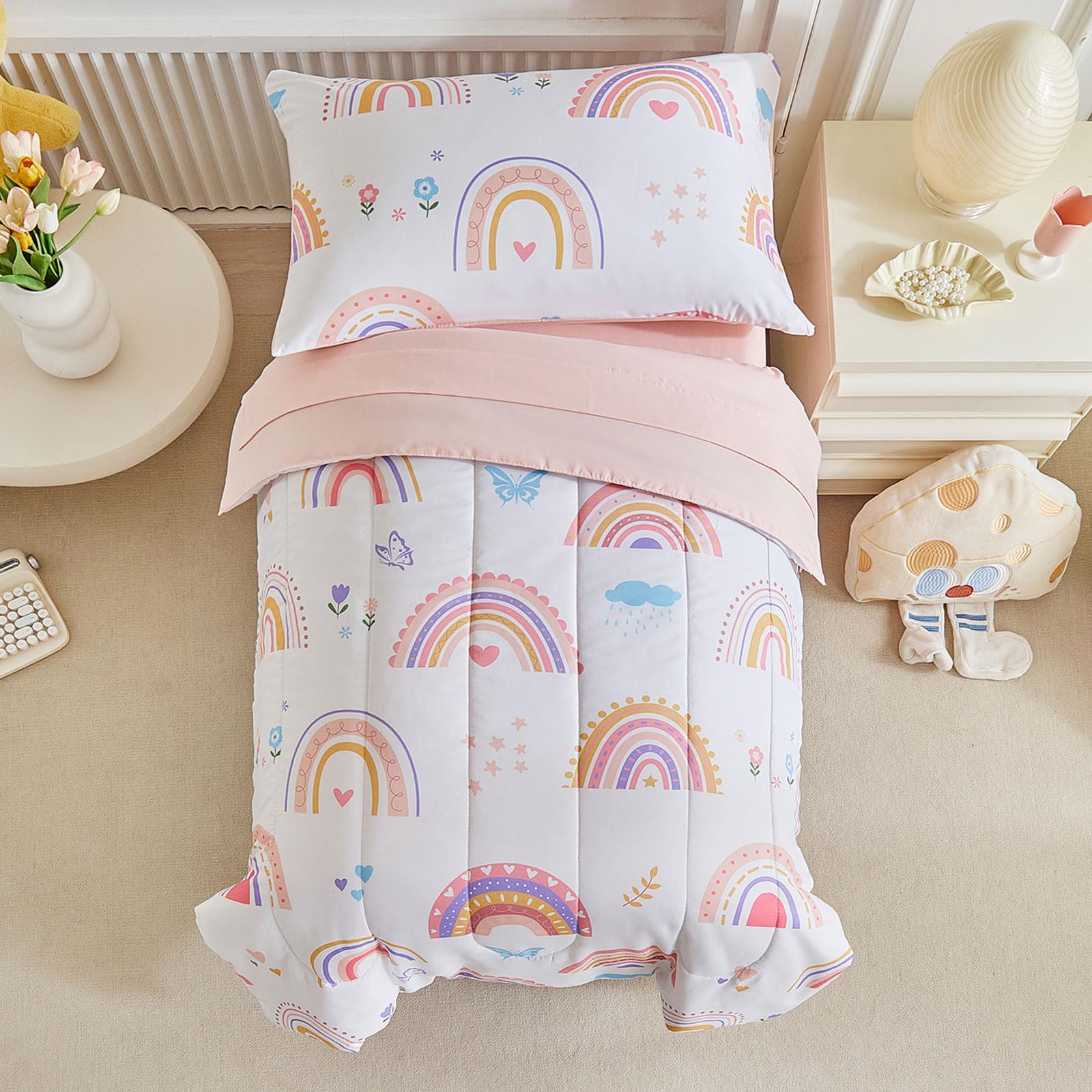 Joyreap pink rainbow toddler bedding set on a bed, promoting cozy bedtime comfort