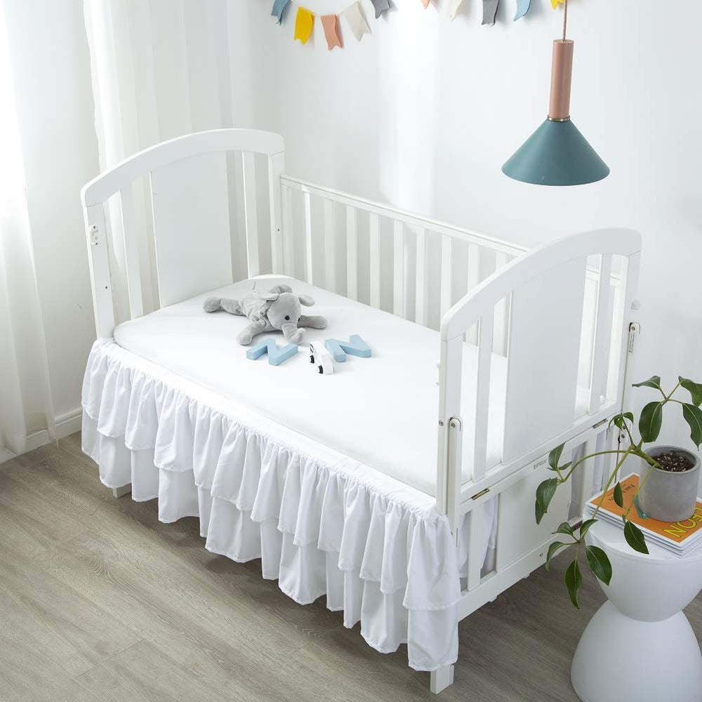 JSD crib skirt sized 52x28 inches with a 14-inch drop hides under-bed storage.
