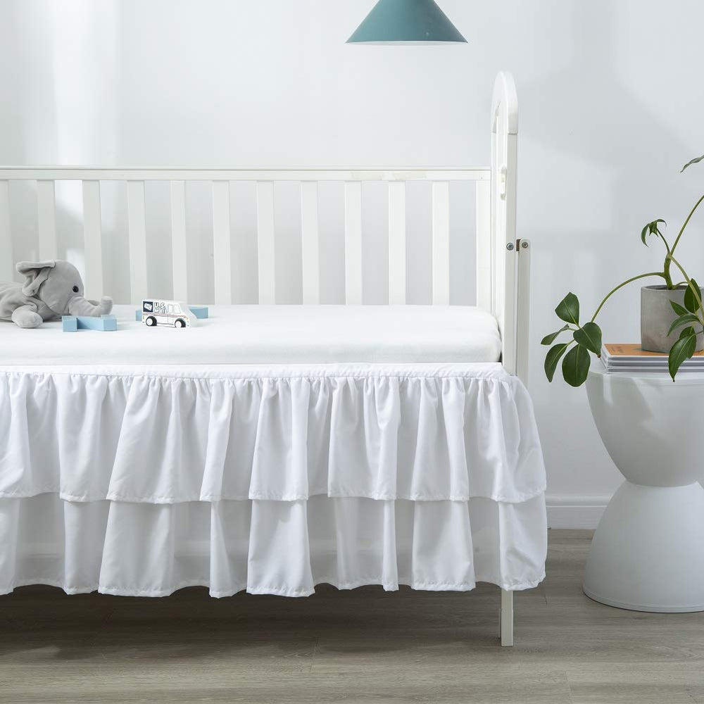 JSD crib skirt with split corners for easy installation and removal.