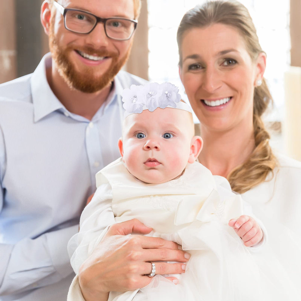 Juinte baby wearing headband with dress ready for photo shoot.
