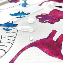 JumpOff Jo pink dinosaur splat mat waterproof design protects floors during spills.