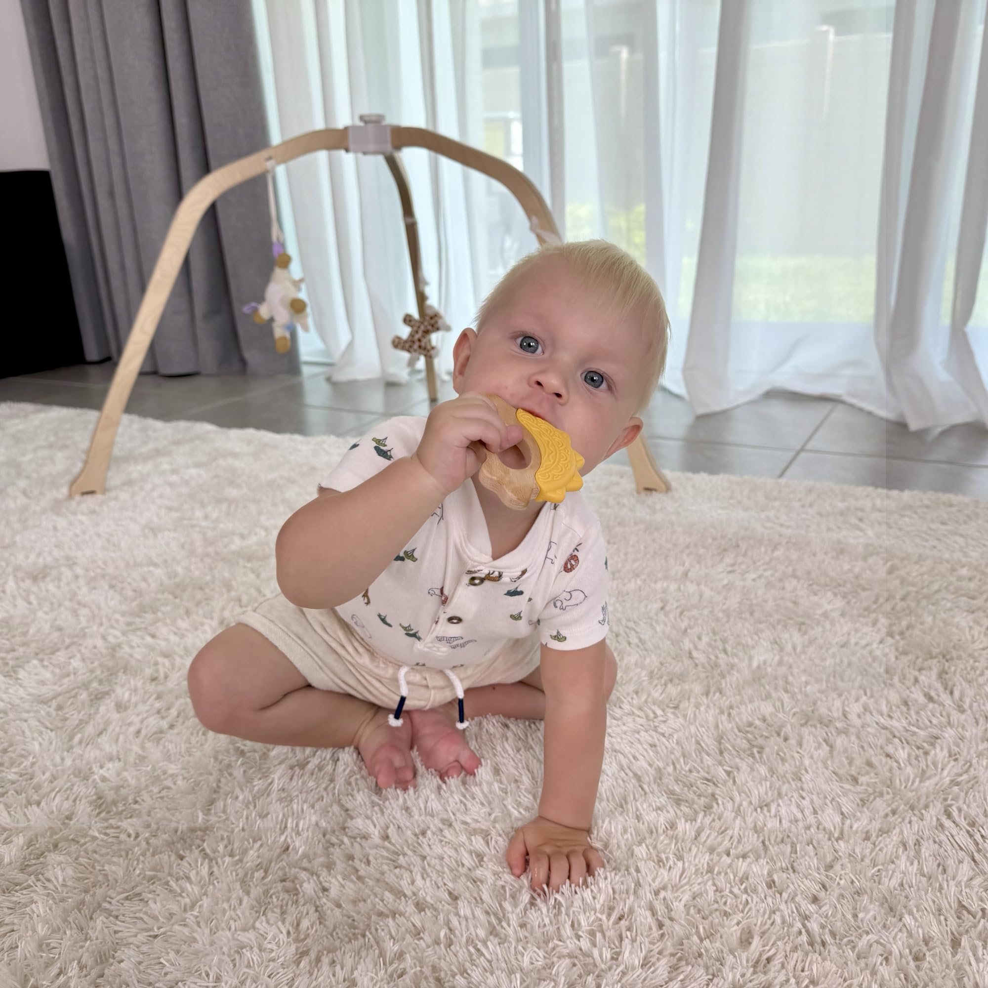 Jununa ergonomic dinosaur wood teether supports small hands and tactile exploration