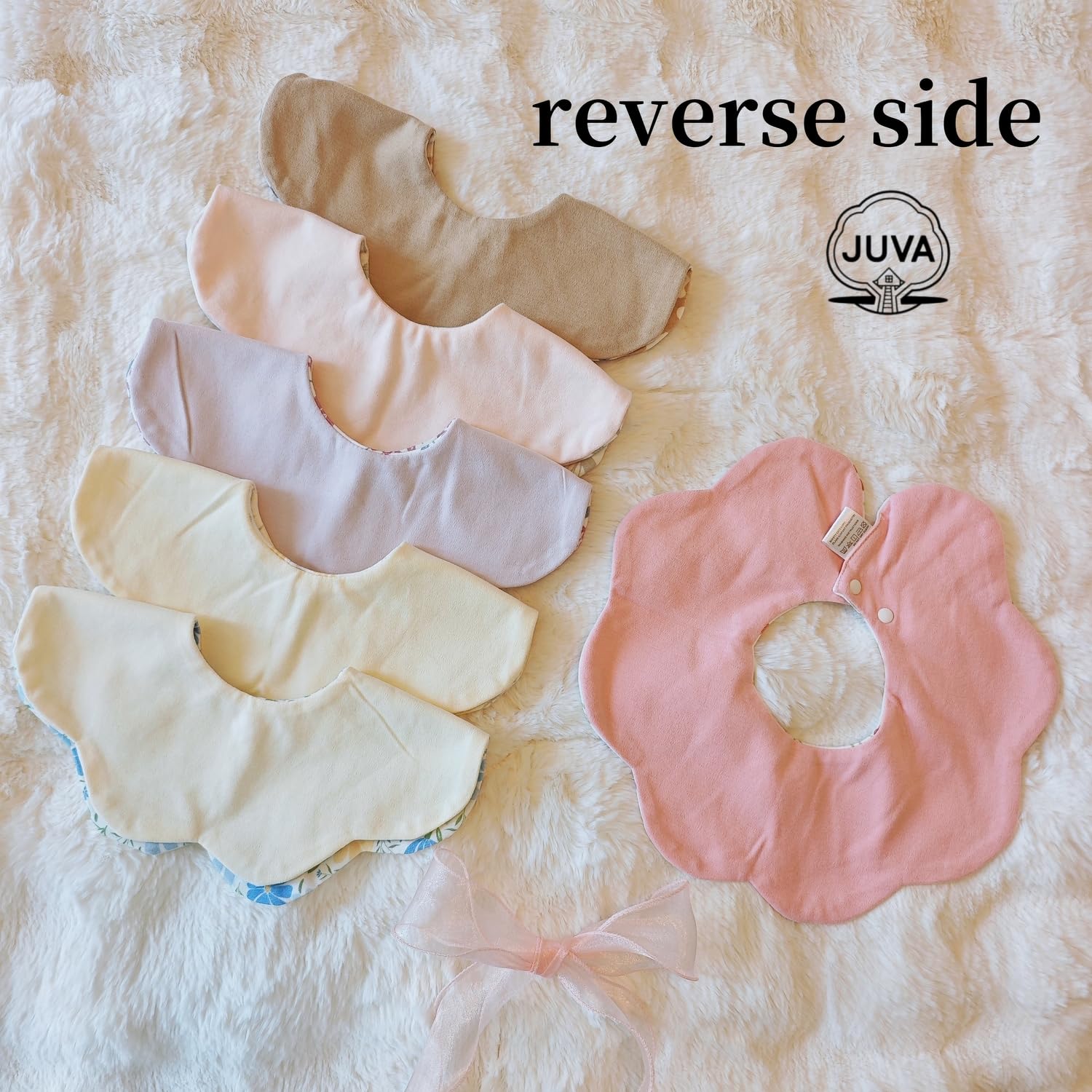 JUVA two-sided flower bib displaying reversible patterns for outfit coordination