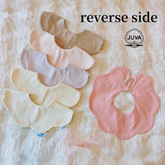 JUVA two-sided flower bib displaying reversible patterns for outfit coordination