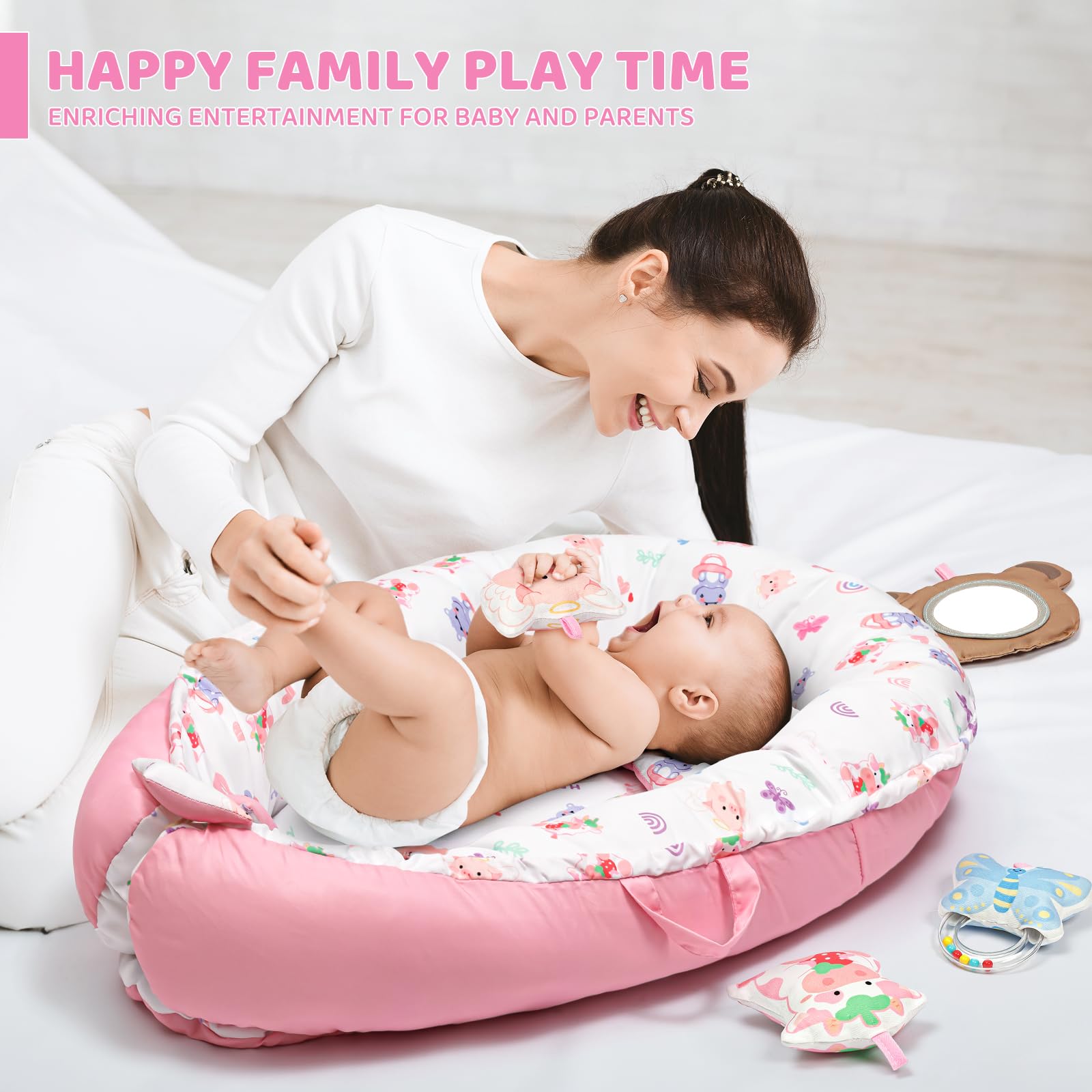 Bright toys on Jyusmile pink mat promote visual tracking during tummy time.