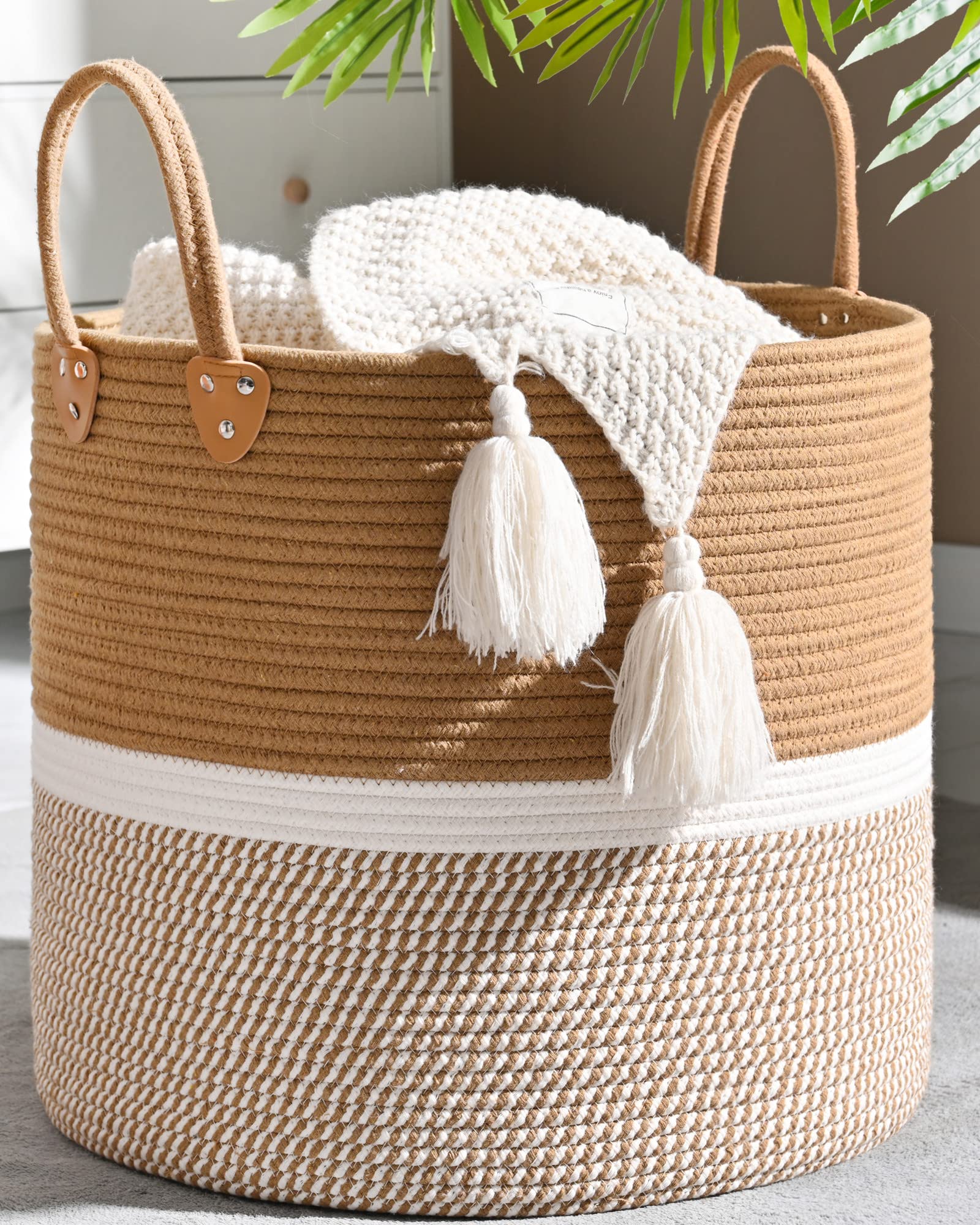 KAKAMAY large blanket basket brown filled with blankets for organized living spaces.