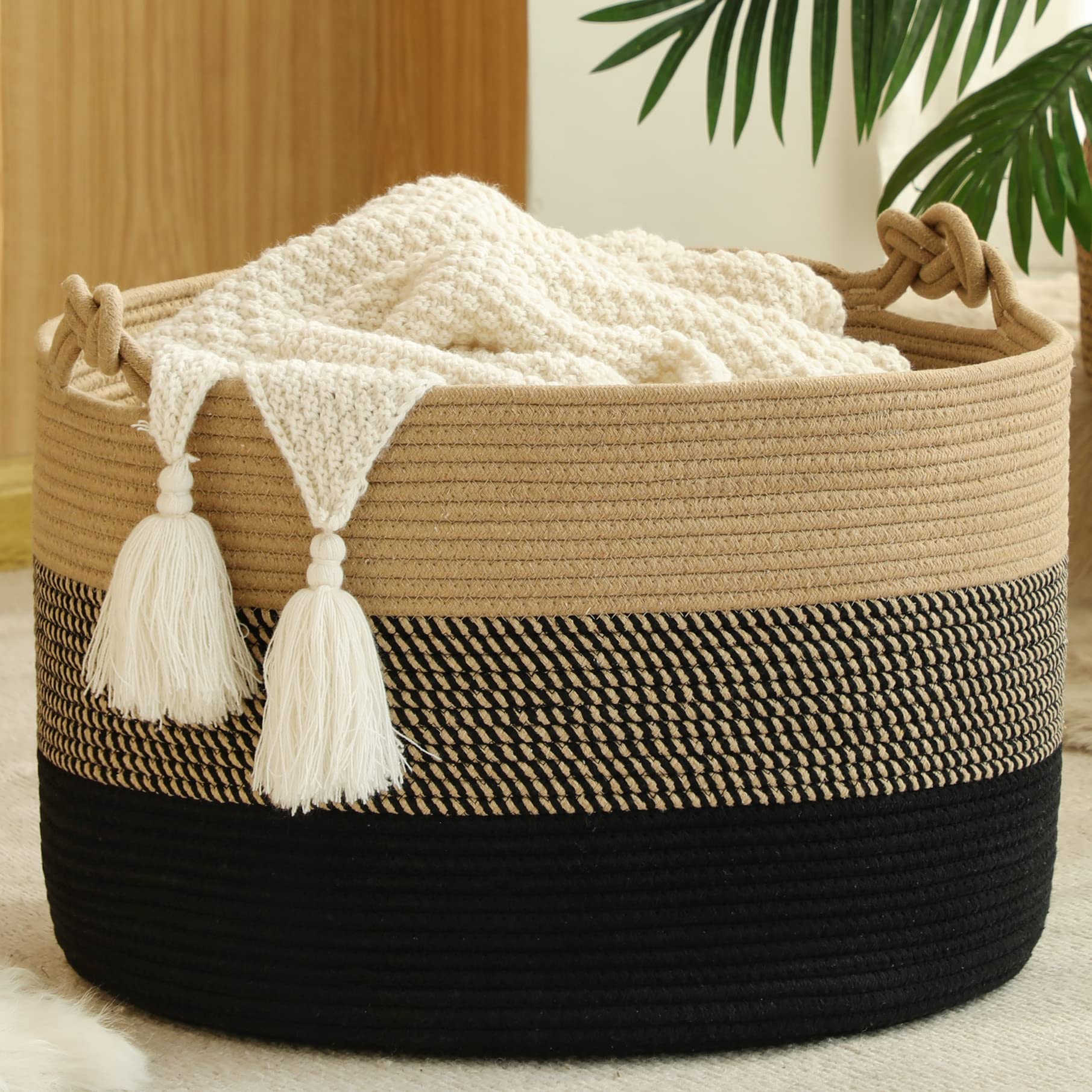 KAKAMAY large blanket basket folded for tidy living room organization.