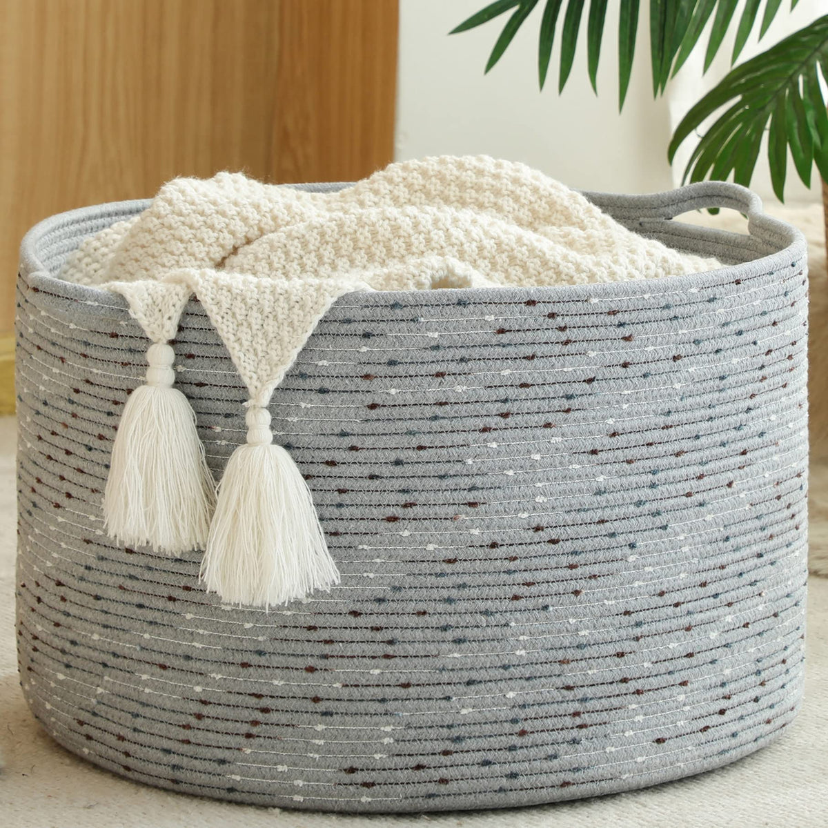 KAKAMAY large blanket basket in living room for neat storage.