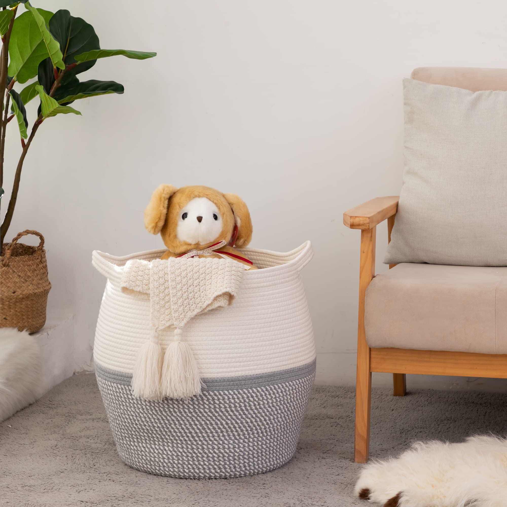KAKAMAY blanket and pillow basket grey adds style and organization to a sofa.