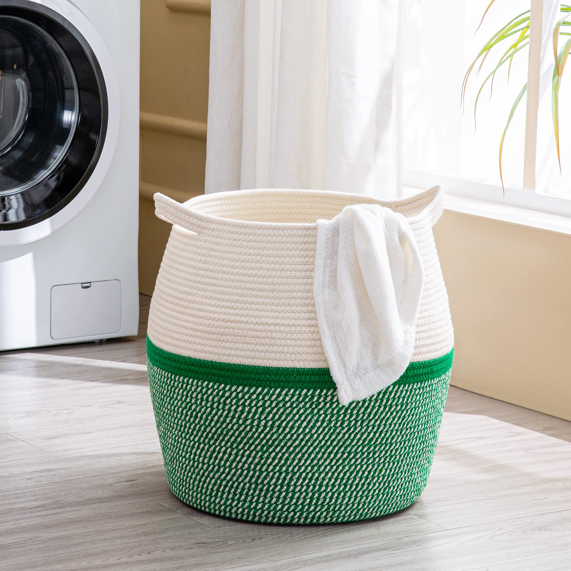 KAKAMAY green basket interior showing roomy capacity for laundry and toys.