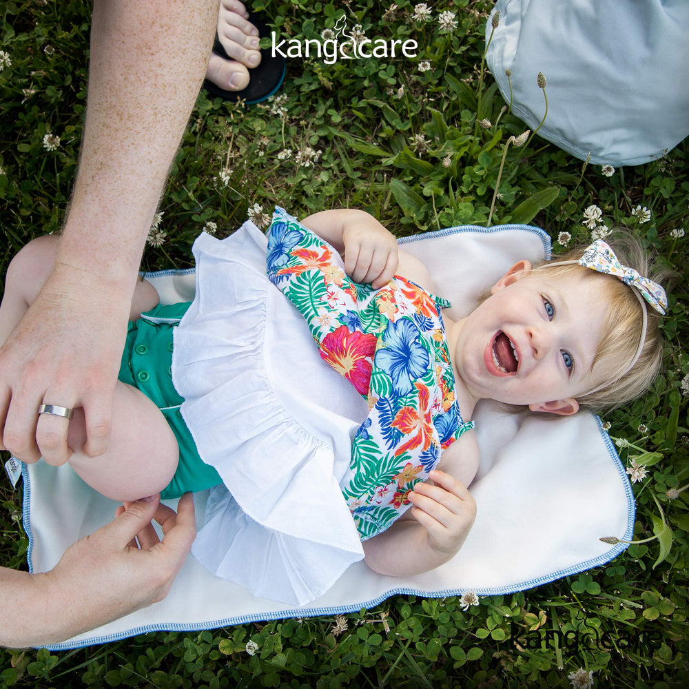 Kanga Care Clover bed protection setup during a diaper change