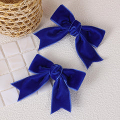 KCHIES royal blue velvet bow clip close-up showing soft texture and gentle grip