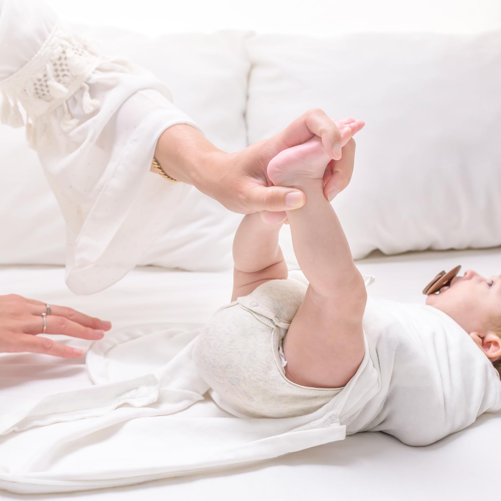 KeaBabies cloud-colored swaddle on baby in crib for cozy night sleep