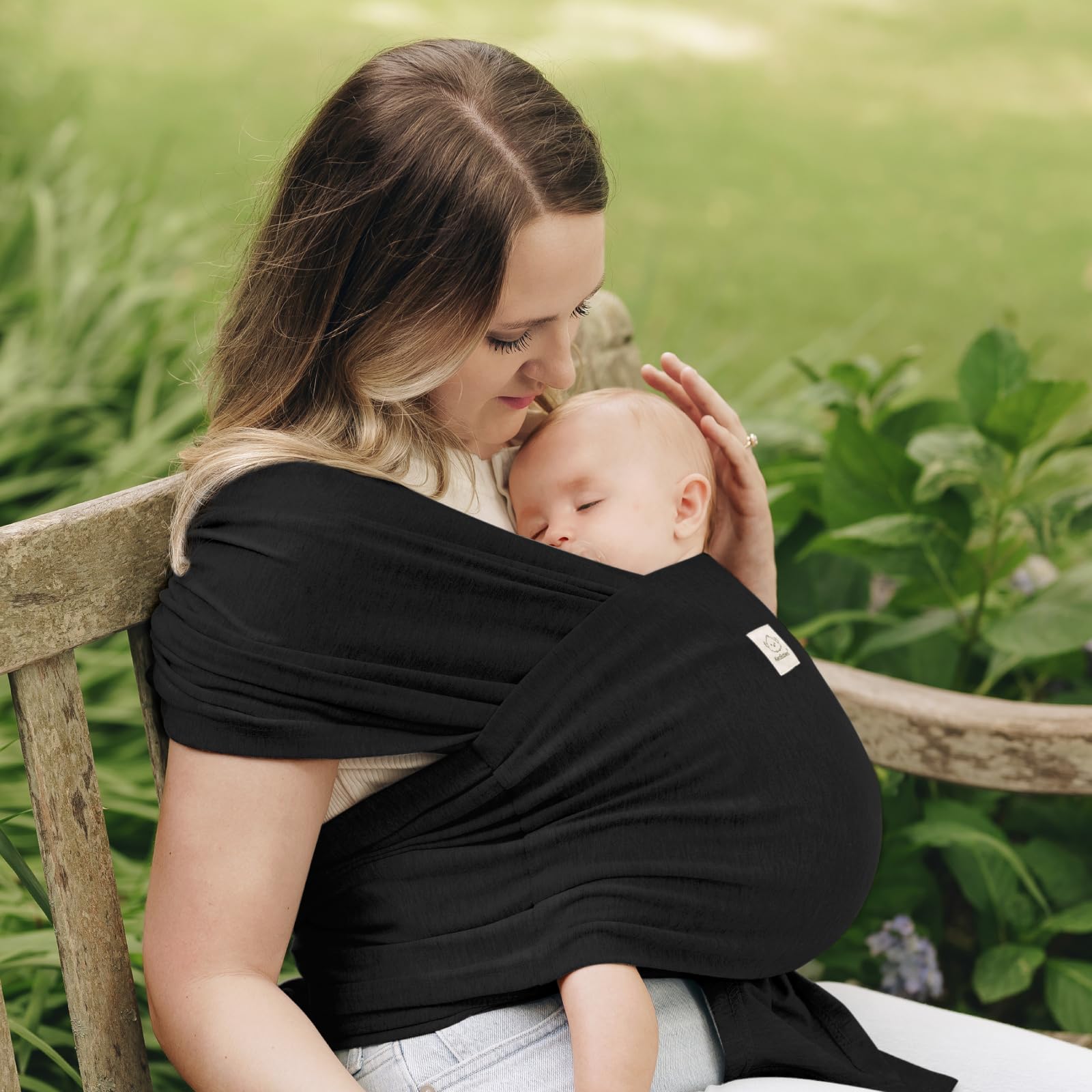 KeaBabies D-Lite ring sling worn by parent with baby close and calm.