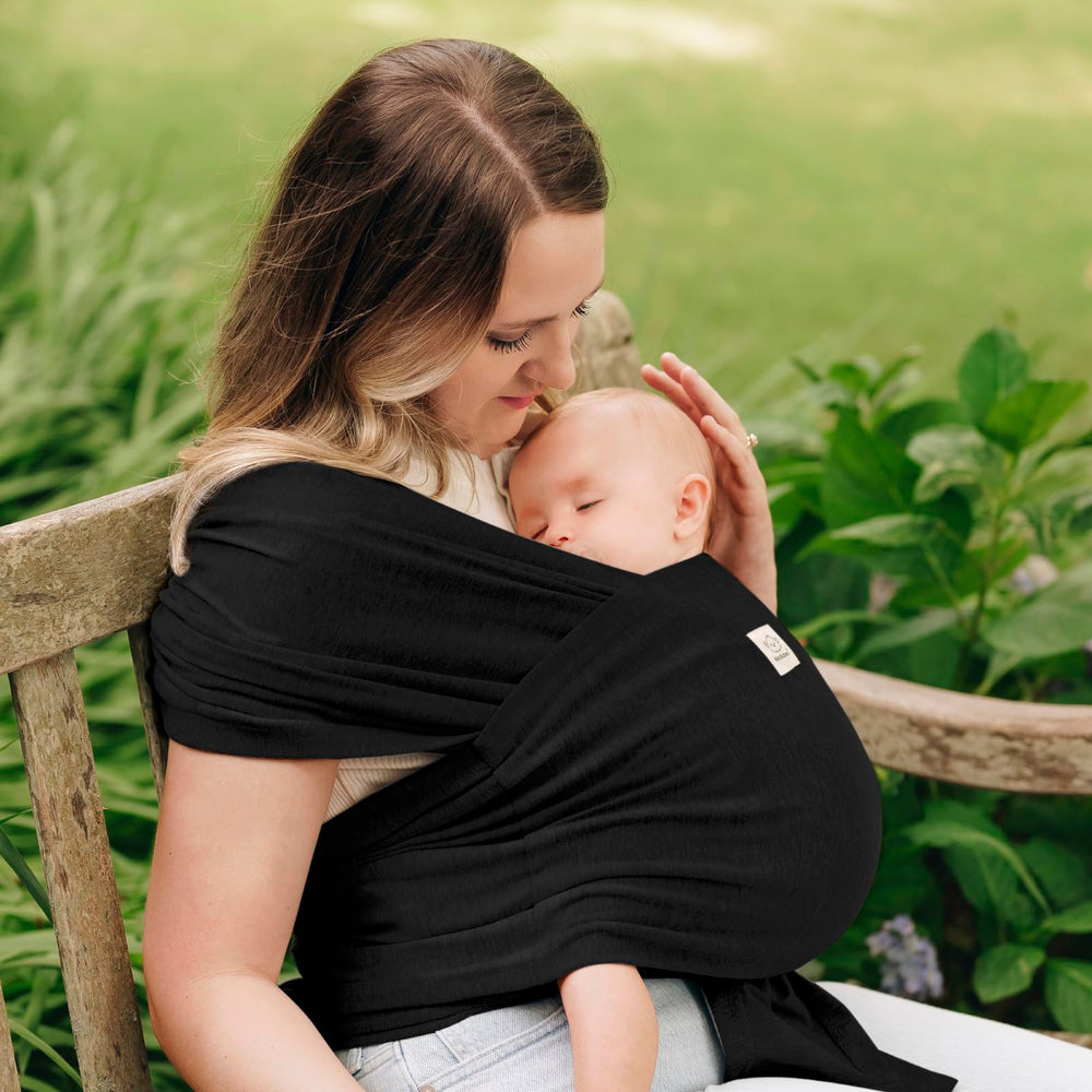 KeaBabies D-Lite ring sling worn by parent with baby close and calm.