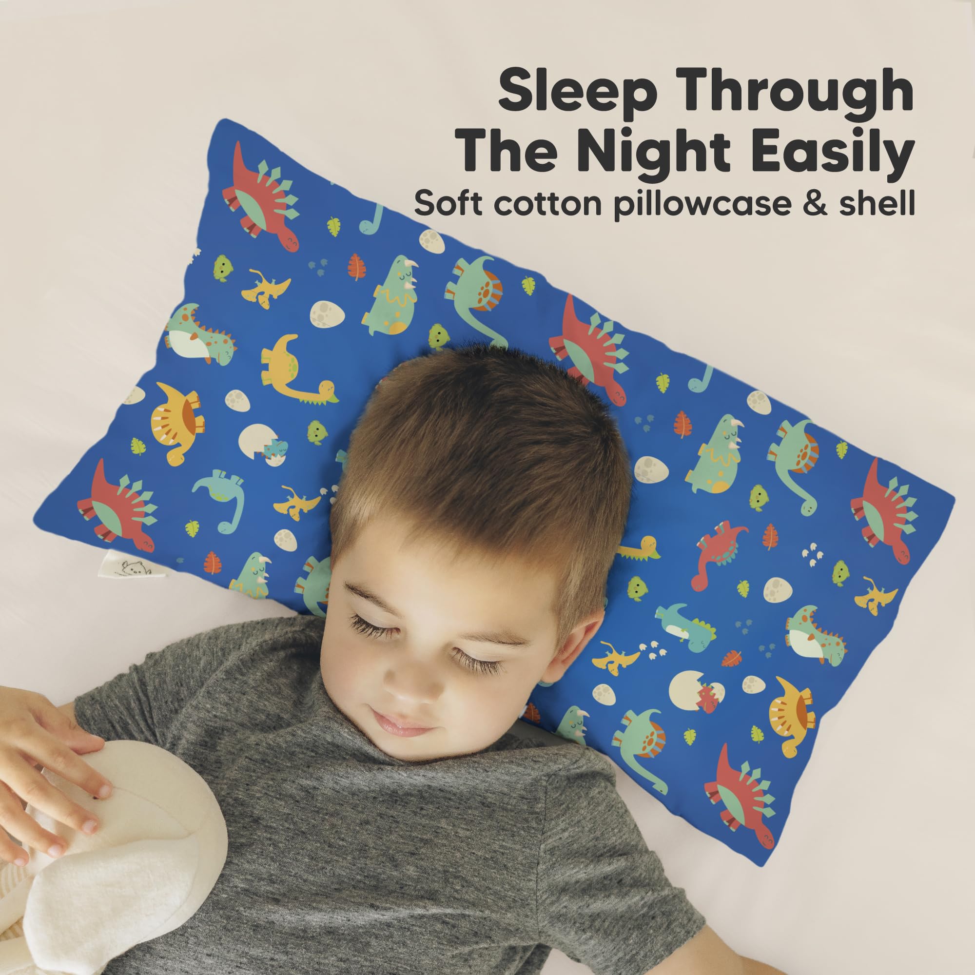 KeaBabies Dinoworld pillow in toddler bed demonstrates small size ideal for preschool naps.